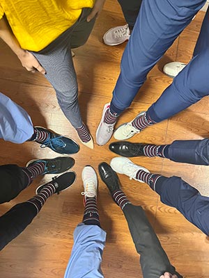Methodist Hospital Specialty and Transplant staff showing their feet in specialty socks.