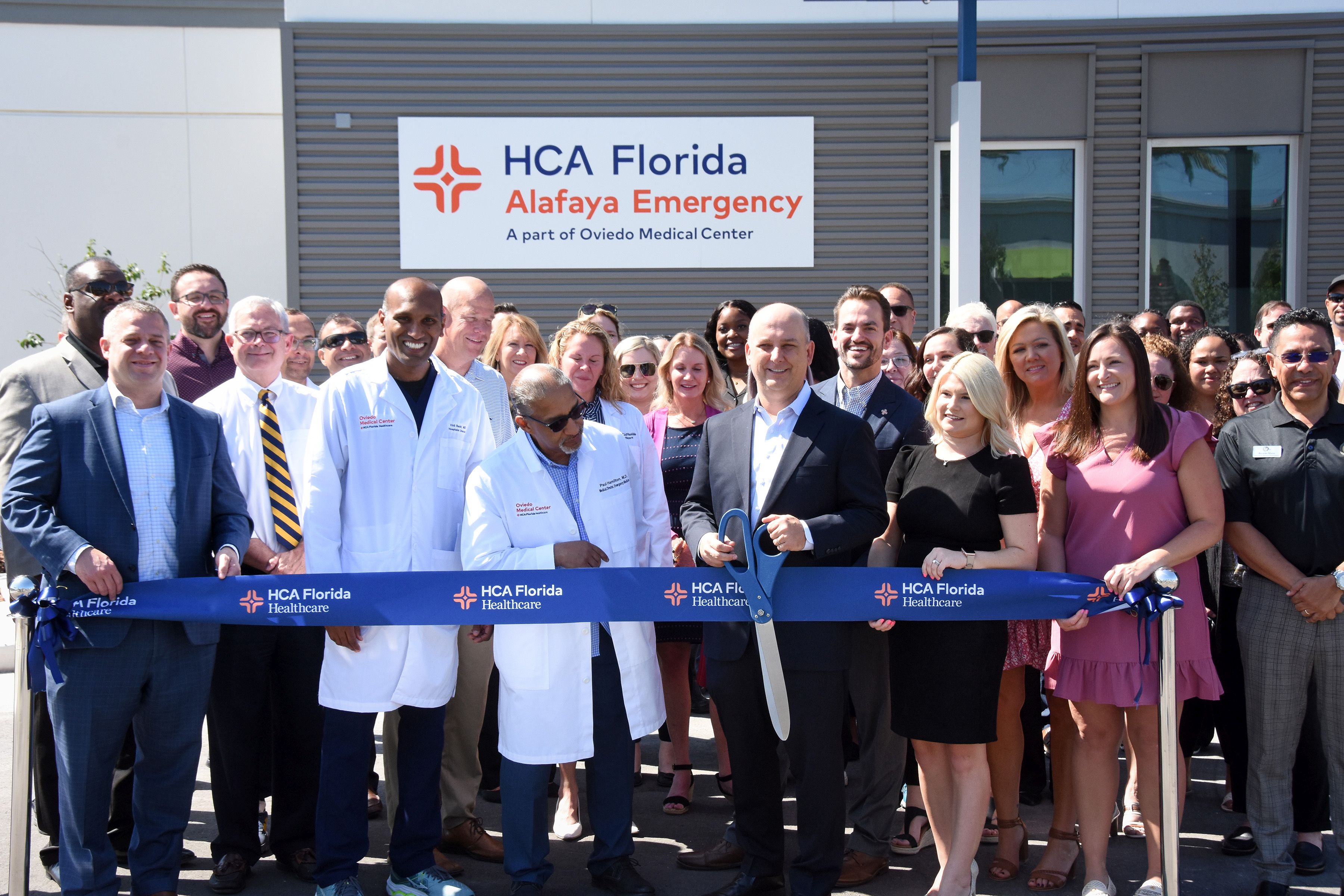 Colleagues outside new HCA Florida Alafaya Emergency facility for ribbon cutting.