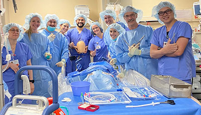 Medical professional staff posing around emergency and surgical equipment in Medical City Fort Worth.