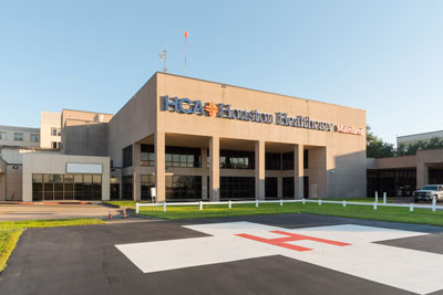 Exterior view of HCA Houston Healthcare Mainland hospital, with the emergency helicopter landing pad in the foreground.