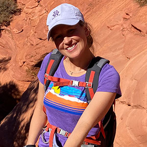 Tara W. smiles during a hiking excursion.