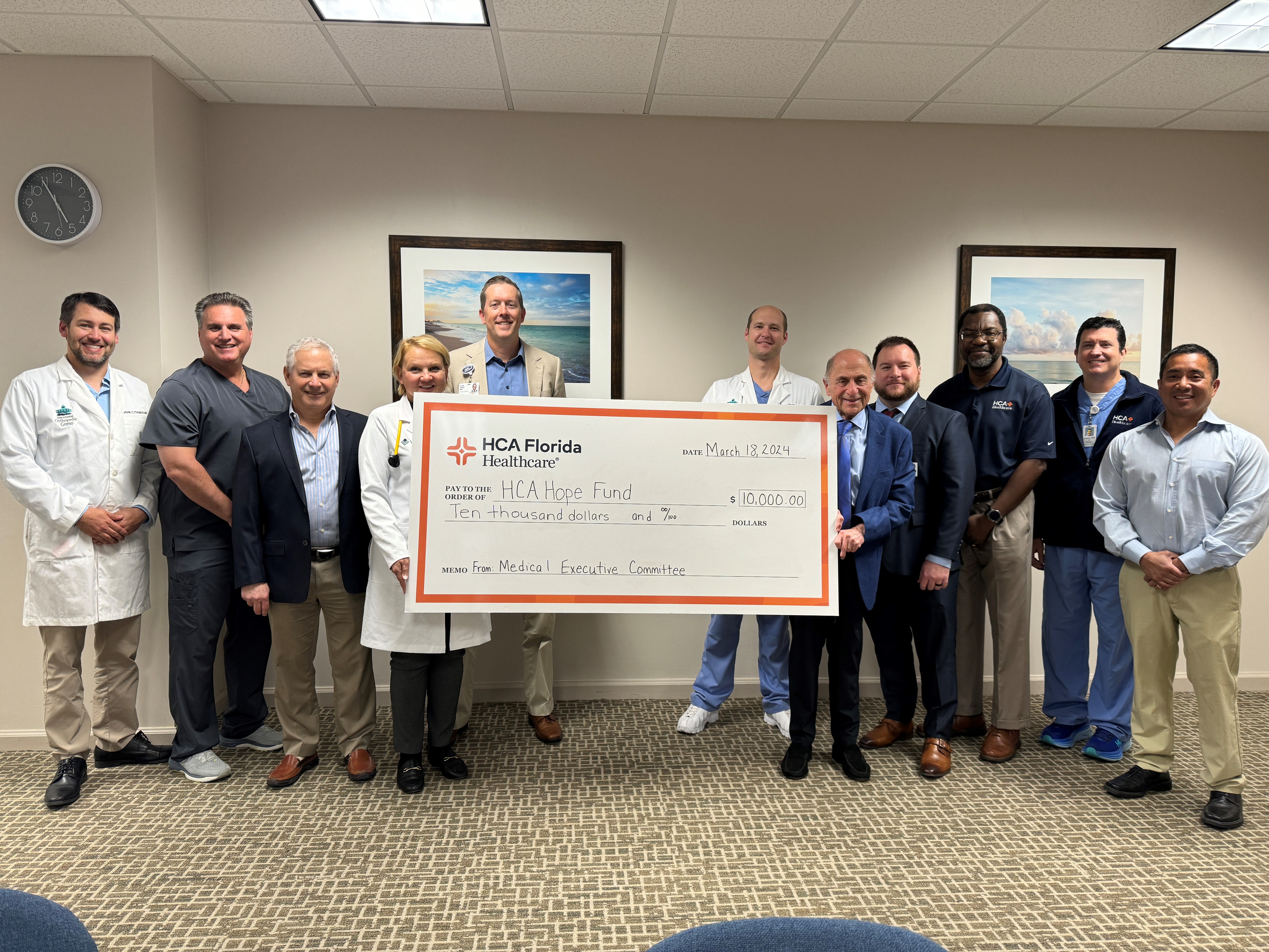 Sarasota Doctors Hospital physicians stand with large check for donation