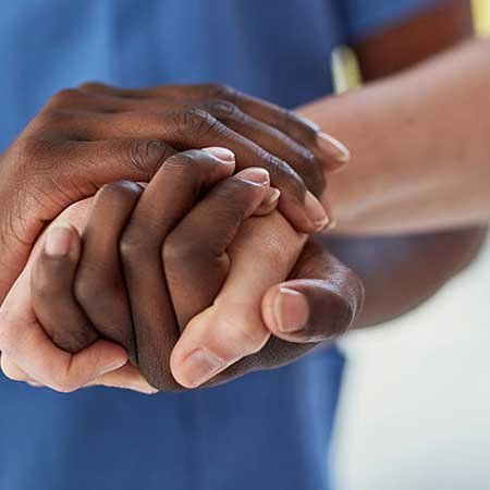 Nurse holding patient's hands