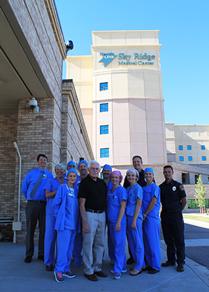 Doug Rowlett and his Sky Ridge team pose together outside of the medical center.