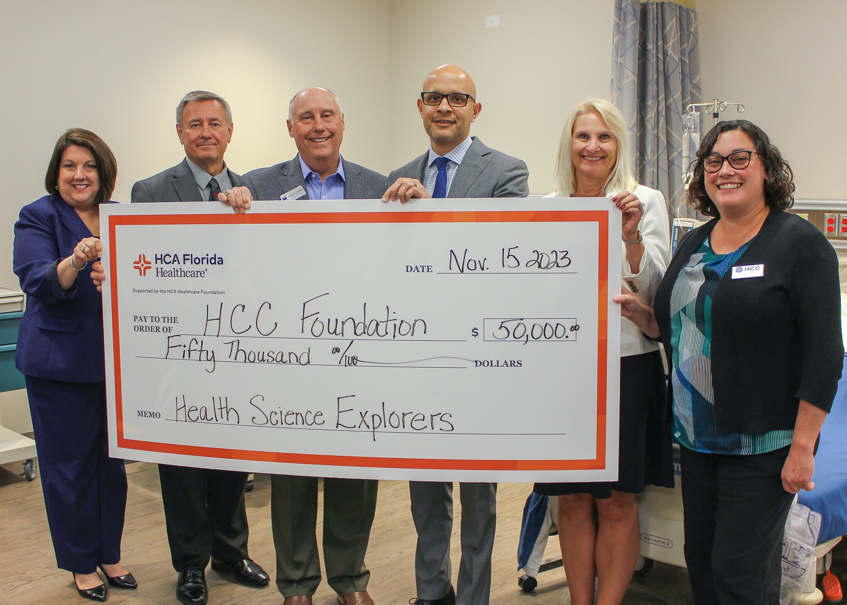 HCA staff pose with $50,000 check to the HCC FOundation.