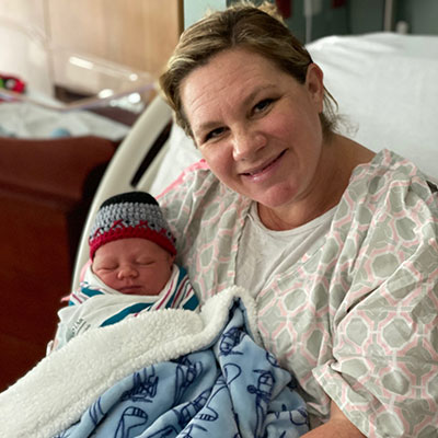Nesha smiles while holding her son, Paxton, after giving birth to him at Cache Valley Hospital.