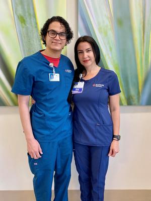 Yovana Valentin, RN, with her son Ricky de Jesus, both wearing HCA Florida Healthcare scrubs.