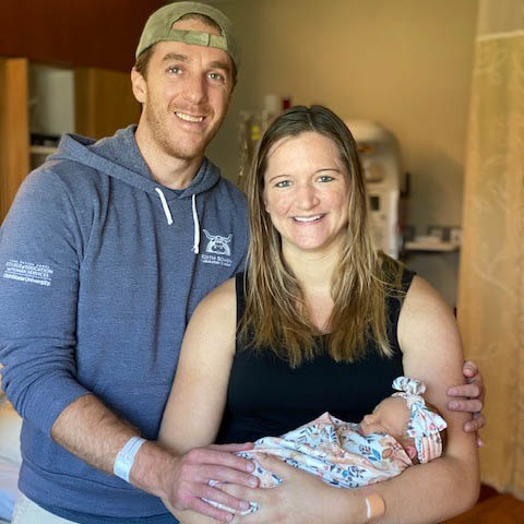 Allison Boling and her husband, Josh, smile while holding their newborn daughter, Alaina.