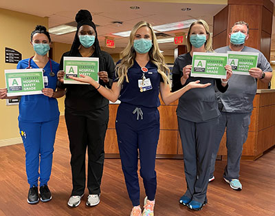 Nurses from HCA Florida Sarasota Doctors Hospital holding 'A' Grades from Leapfrog Group.