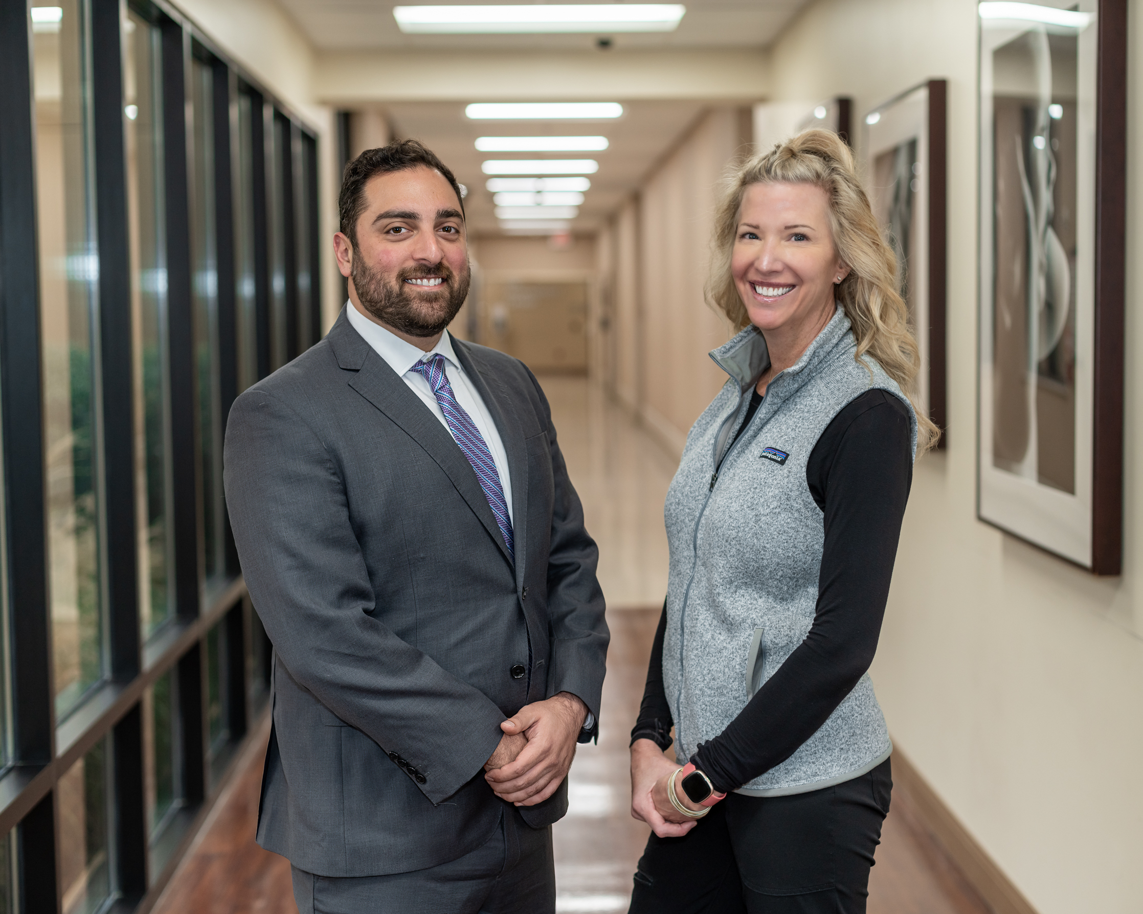 Dr. Jameil Abou-Hanna, general and bariatric surgery, and Regina Dunn, bariatrics coordinator, smile in the hallway of TriStar Hendersonville Medical Center.