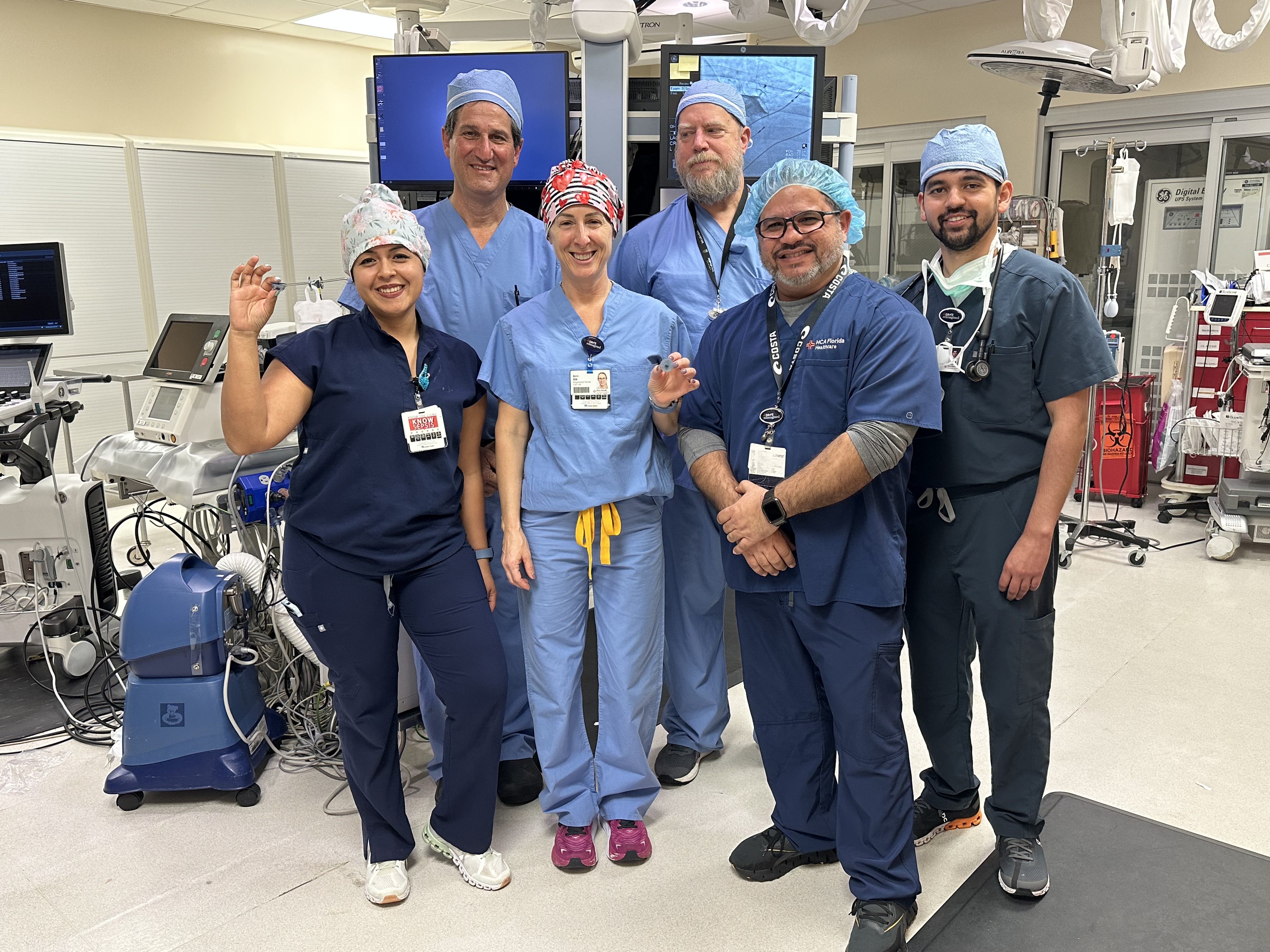 Surgery team posing in operating room.