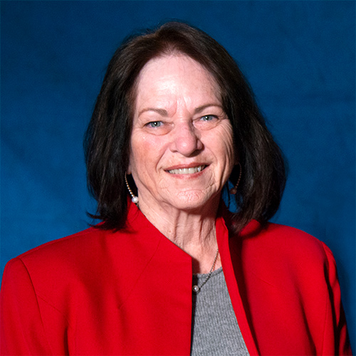 Dr. Sheryl Steadman smiling, wearing a red blazer.