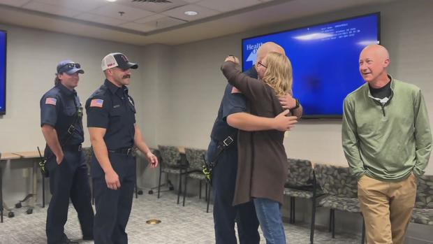 Jennifer Harlan hugs first responder who helped save her life.