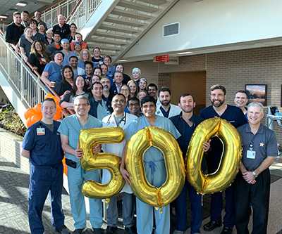 Team members pose with balloons to celebrate 500th Transcatheter Aortic Valve Replacement (TAVR) procedure.