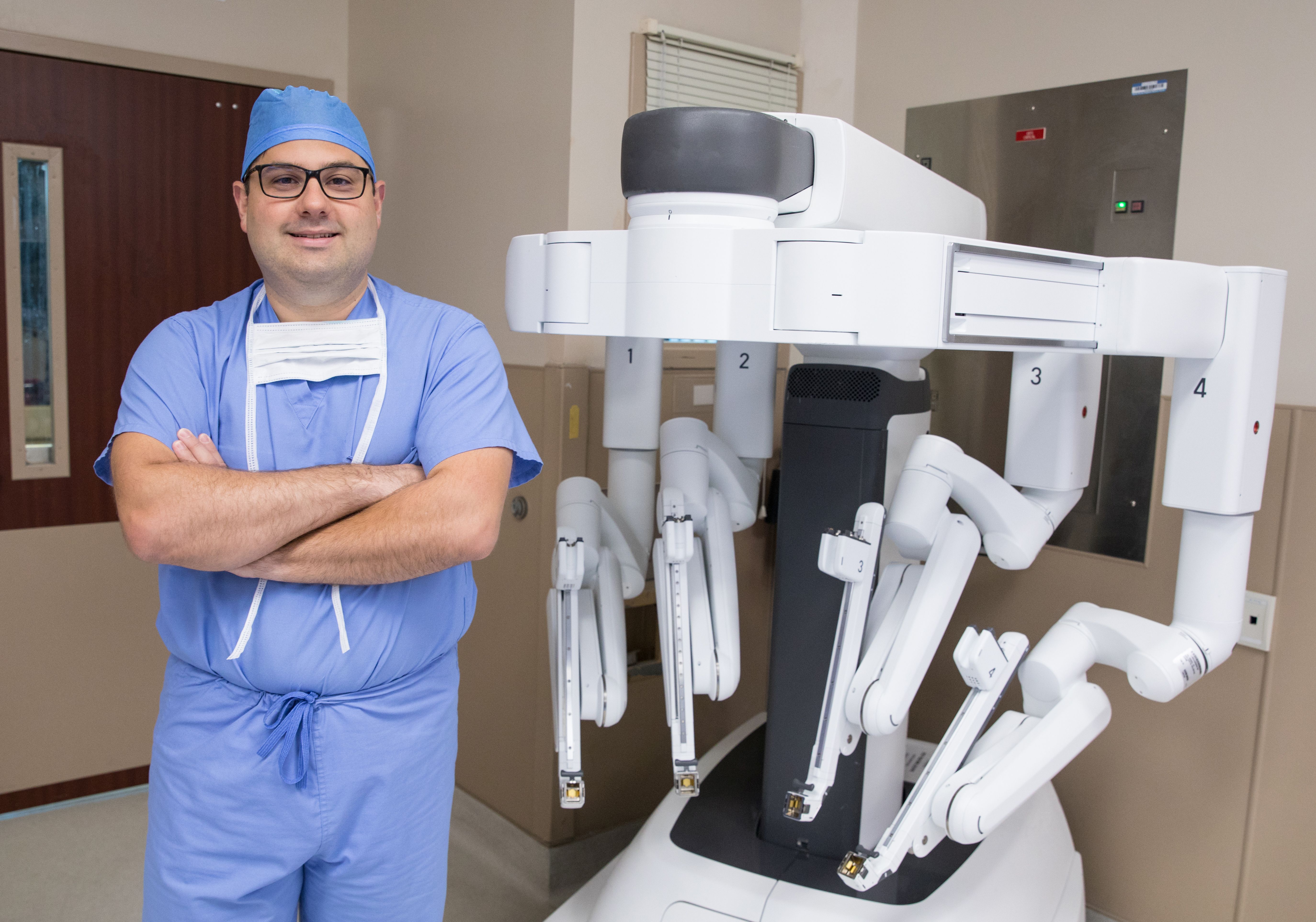 Dr. Francisco Macedo pictured with the surgical robotic system.