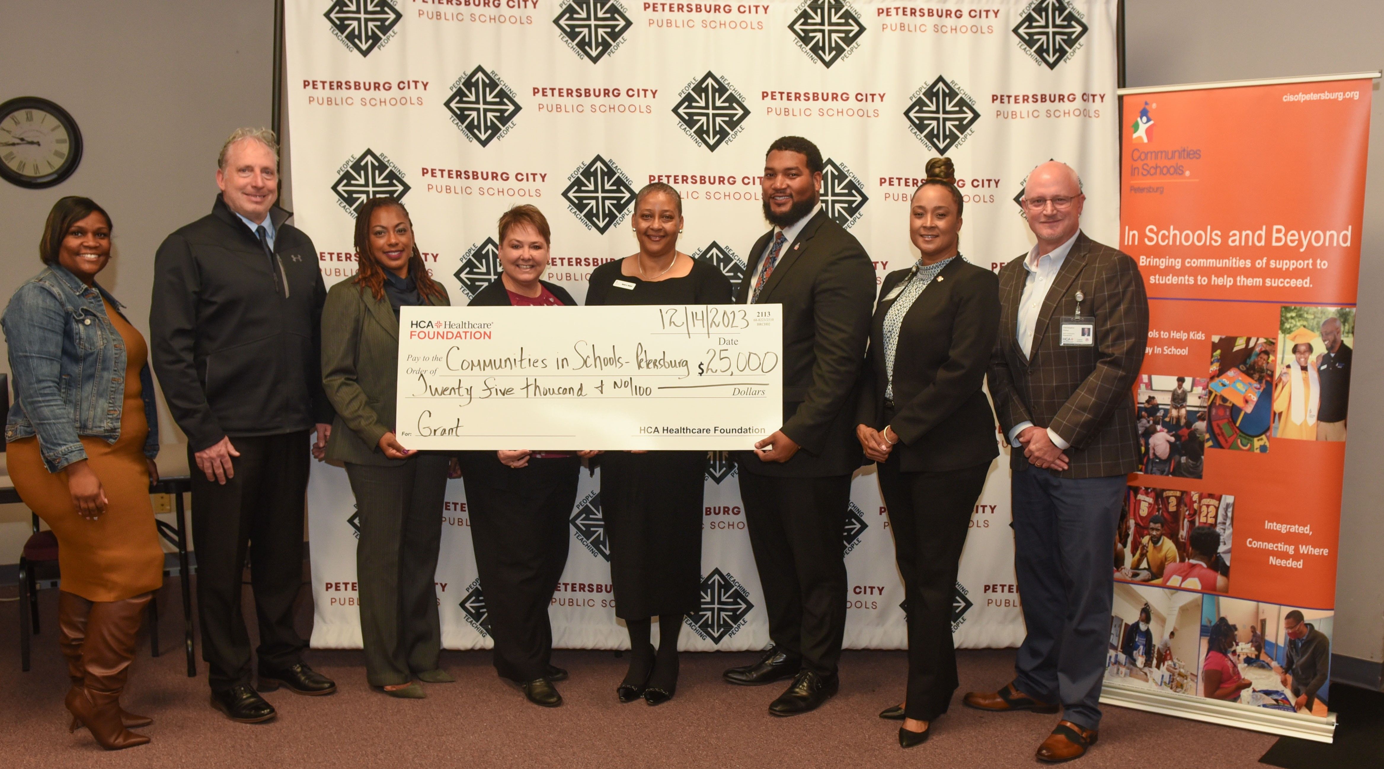 HCA colleagues present $25,000 check
