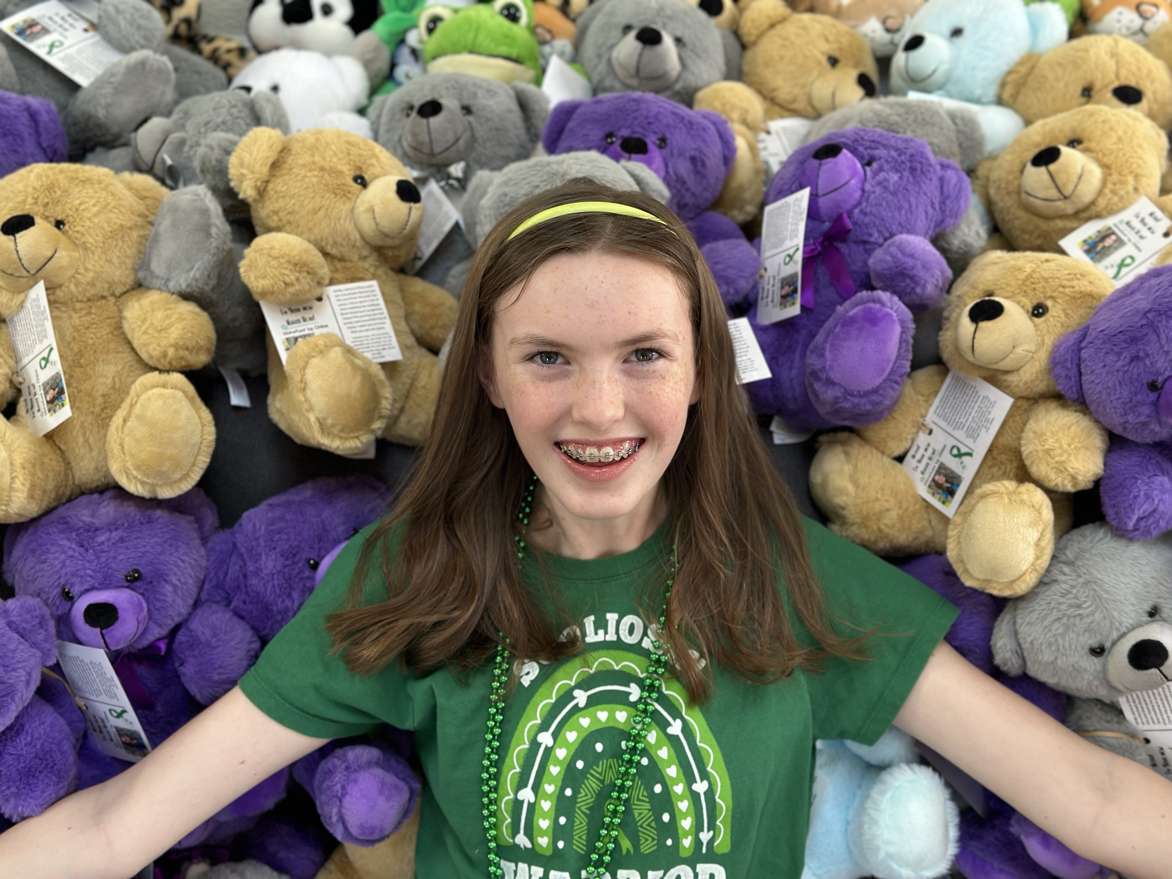 Chloe posing with the teddy bears for donation.