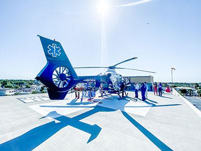 Fawcett Hospital staff touring medical helicopter on hospital helipad