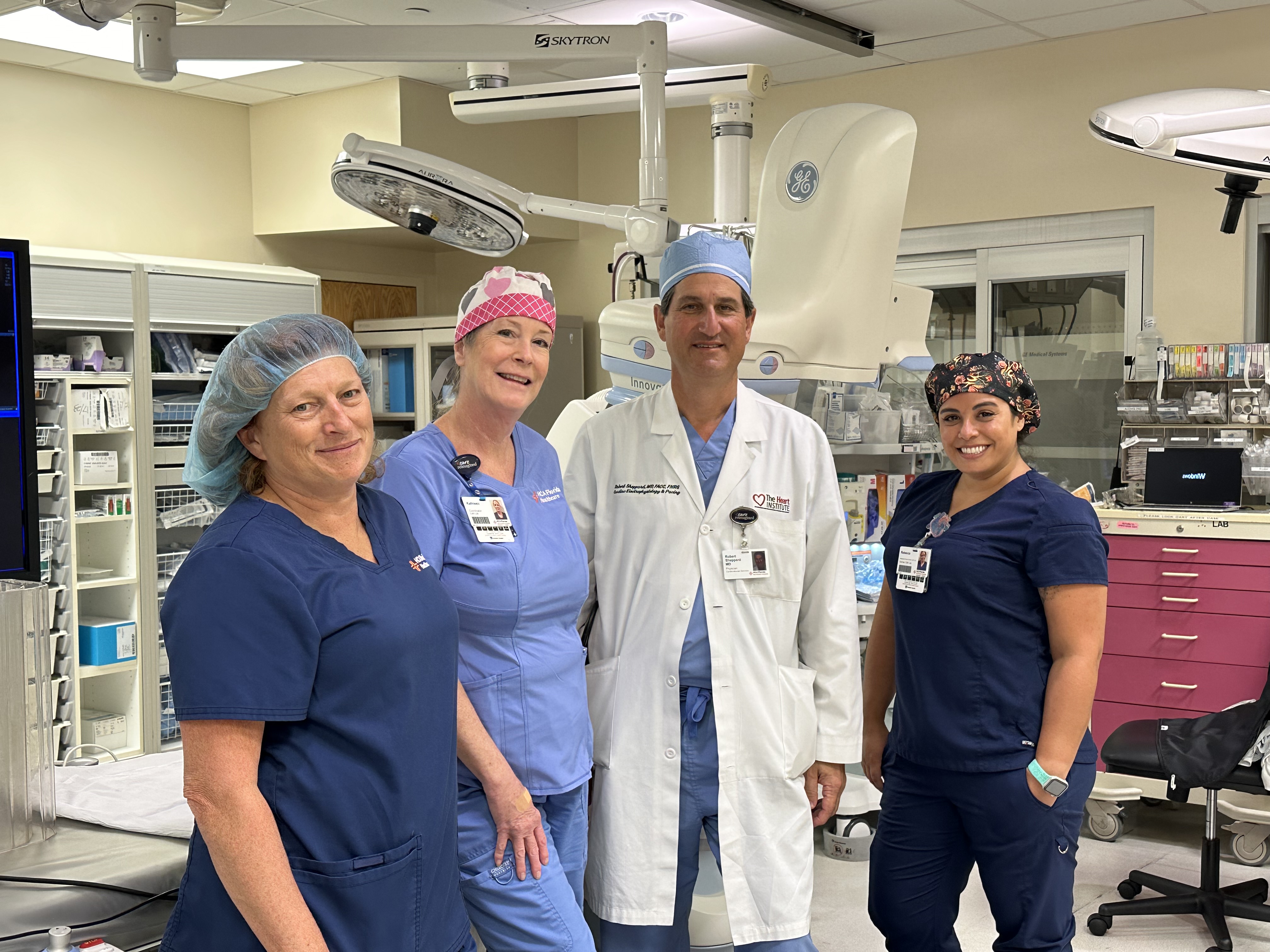 Dr. Sheppard poses with some of the EP team and a surgical robot after the first new A-fib procedure.
