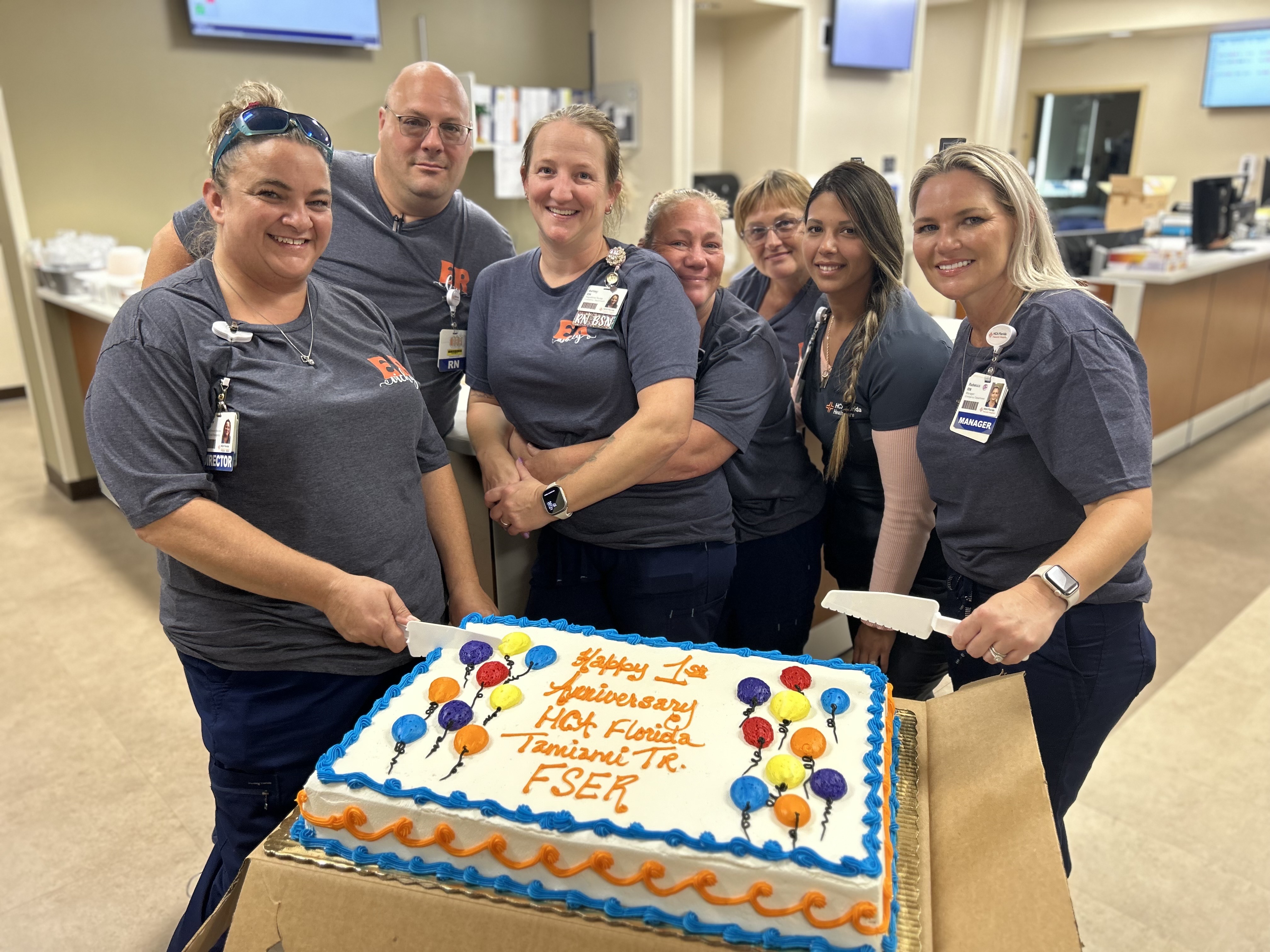 HCA colleagues celebrate 1yr anniversary of facility opening with ER and EMS staff.
