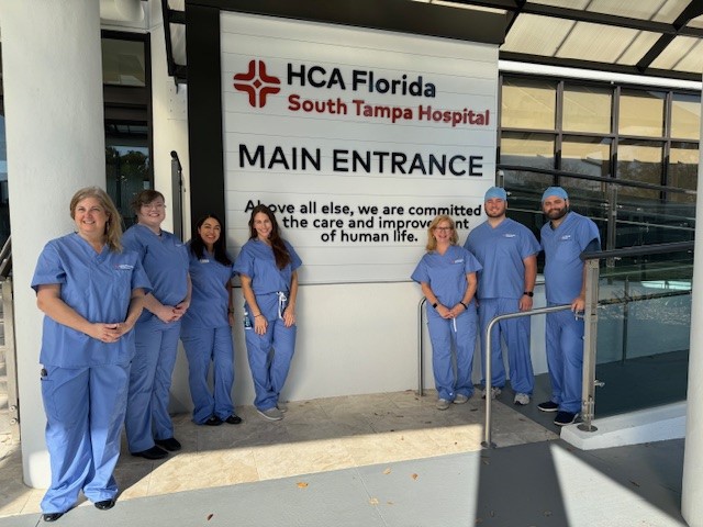 Hospital ambassadors pose in front of the HCA Florida South Tampa Hospital newly renovated Main Entrance.
