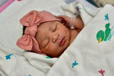 Baby Naomi, the first baby born at Medical City Arlington in 2024, wrapped in a blanket with ducks on it.