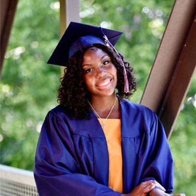 Kalynn Holmes-Butler in a graduation robe and cap.