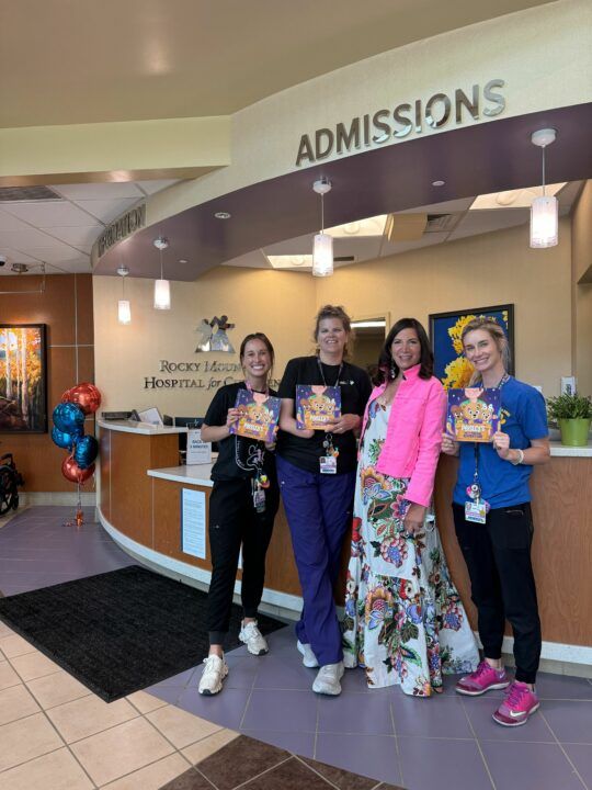 Local author Gail Nussbaum and three hospital staff members