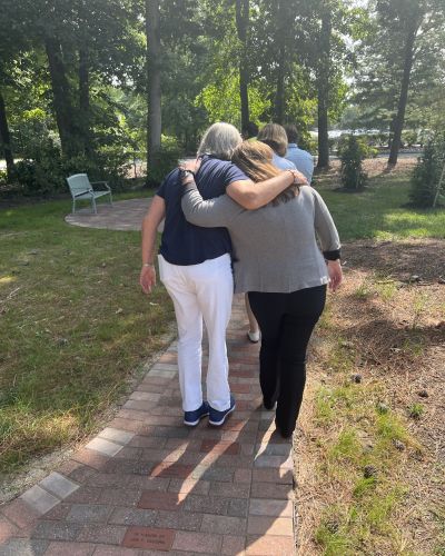 Steven Cohen and Melannie Huber-Cohen hugging in the Memorial Garden.