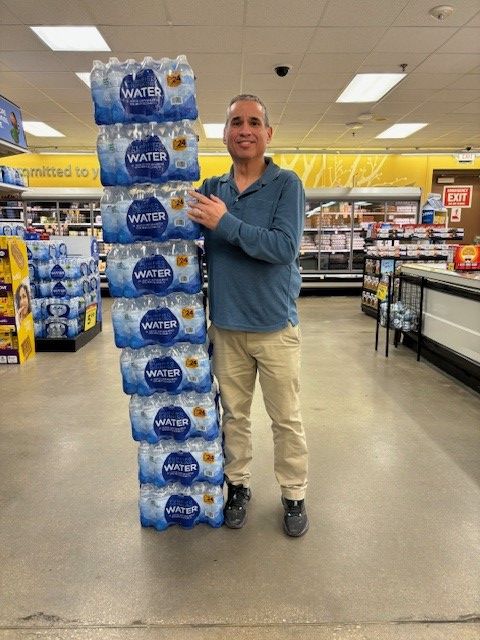 Chris Phelps with stack of cases of bottled water